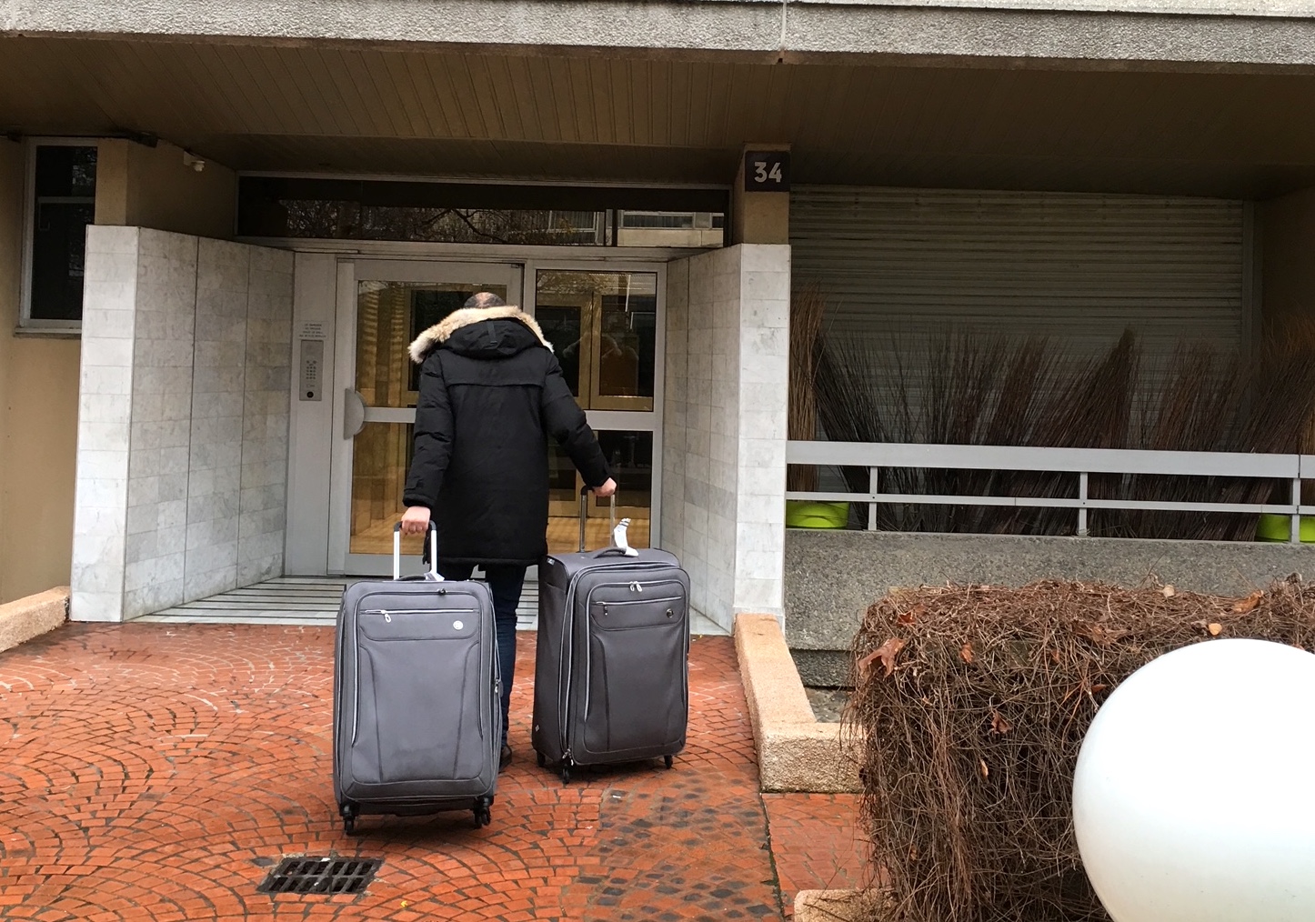 A cab driver in Paris pulling Linda's two suitcases to her new apartment