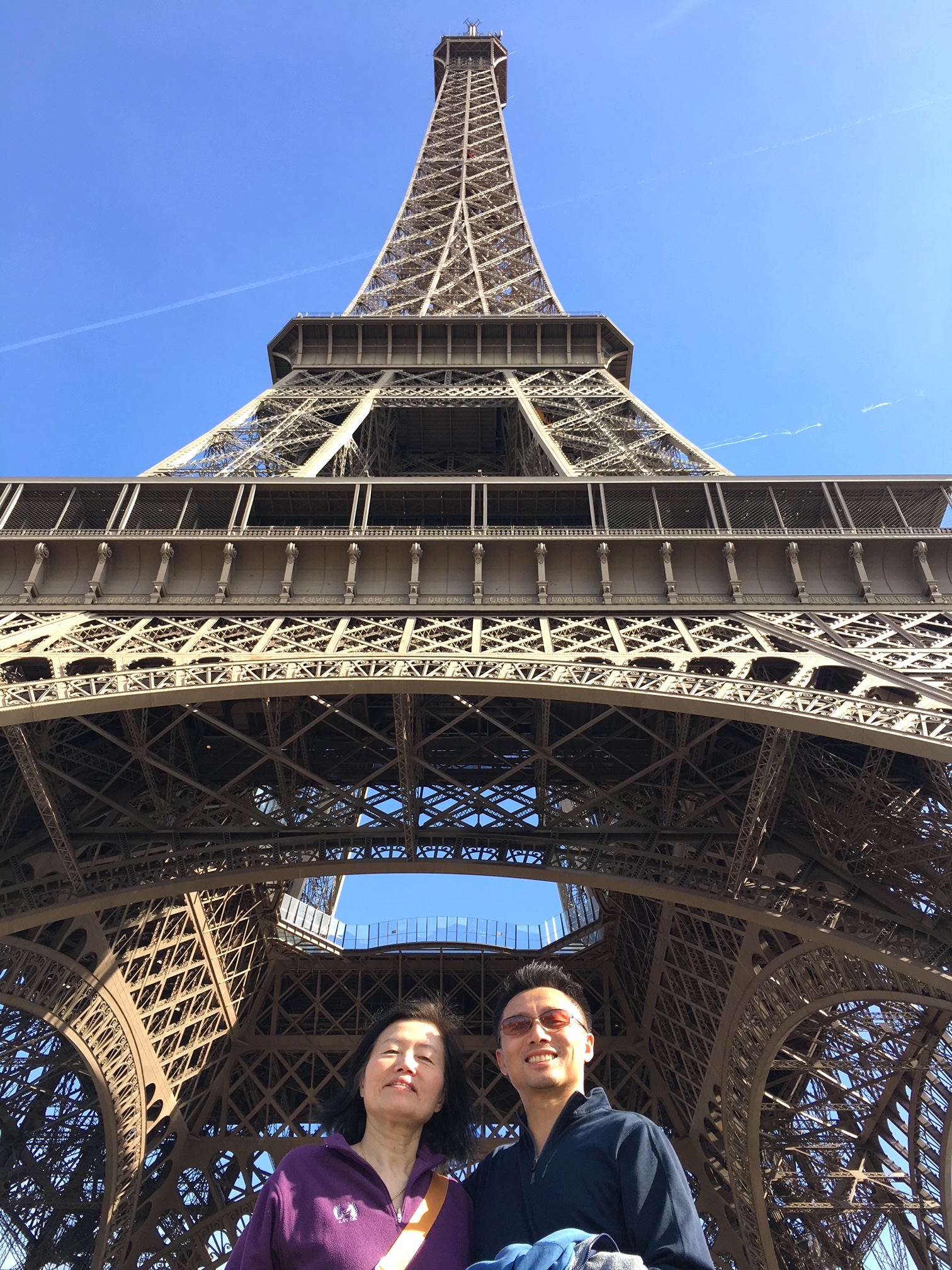 Andrew and his mom under the Eiffel Tower before the first climb