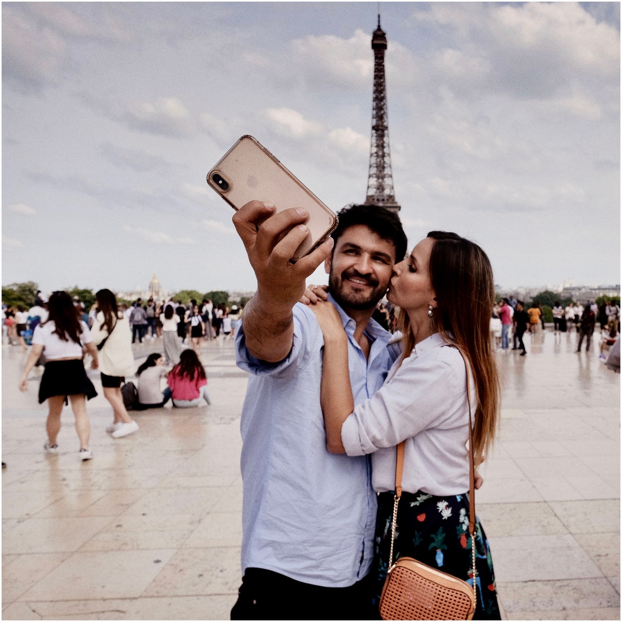 Couple taking a photo at the Eiffel Tower