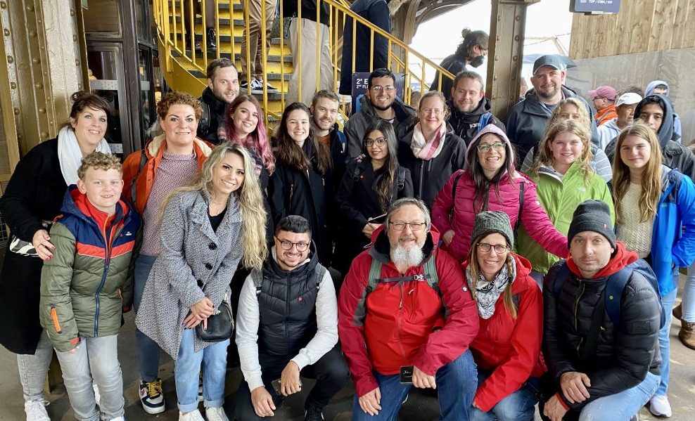 eiffel tower climb tour group posing for photo after climbing by stairs